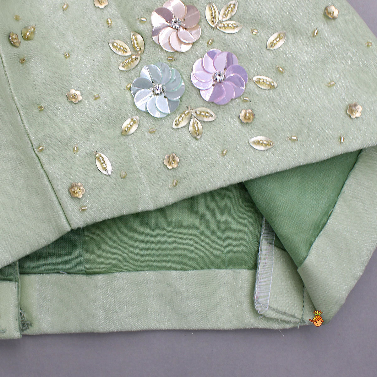 Pre Order: Floral Embroidered Green Sleeveless Top And Fabric Flower Tassels Adorned Lehenga With Ruffle Dupatta