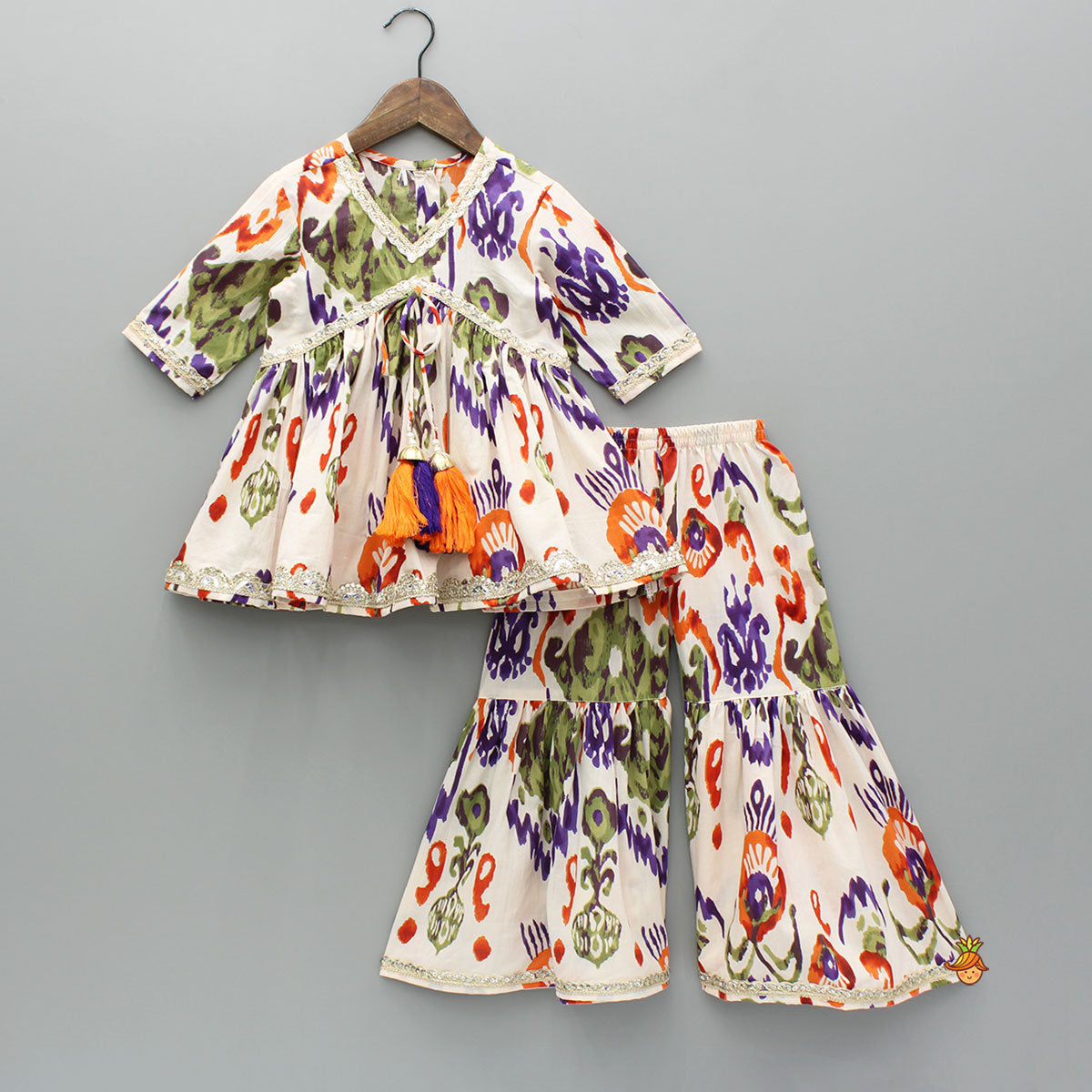 Pre Order: Tassels Enhanced Multicolour Printed Kurti And Sharara With Scalloped Lace Detail Dupatta