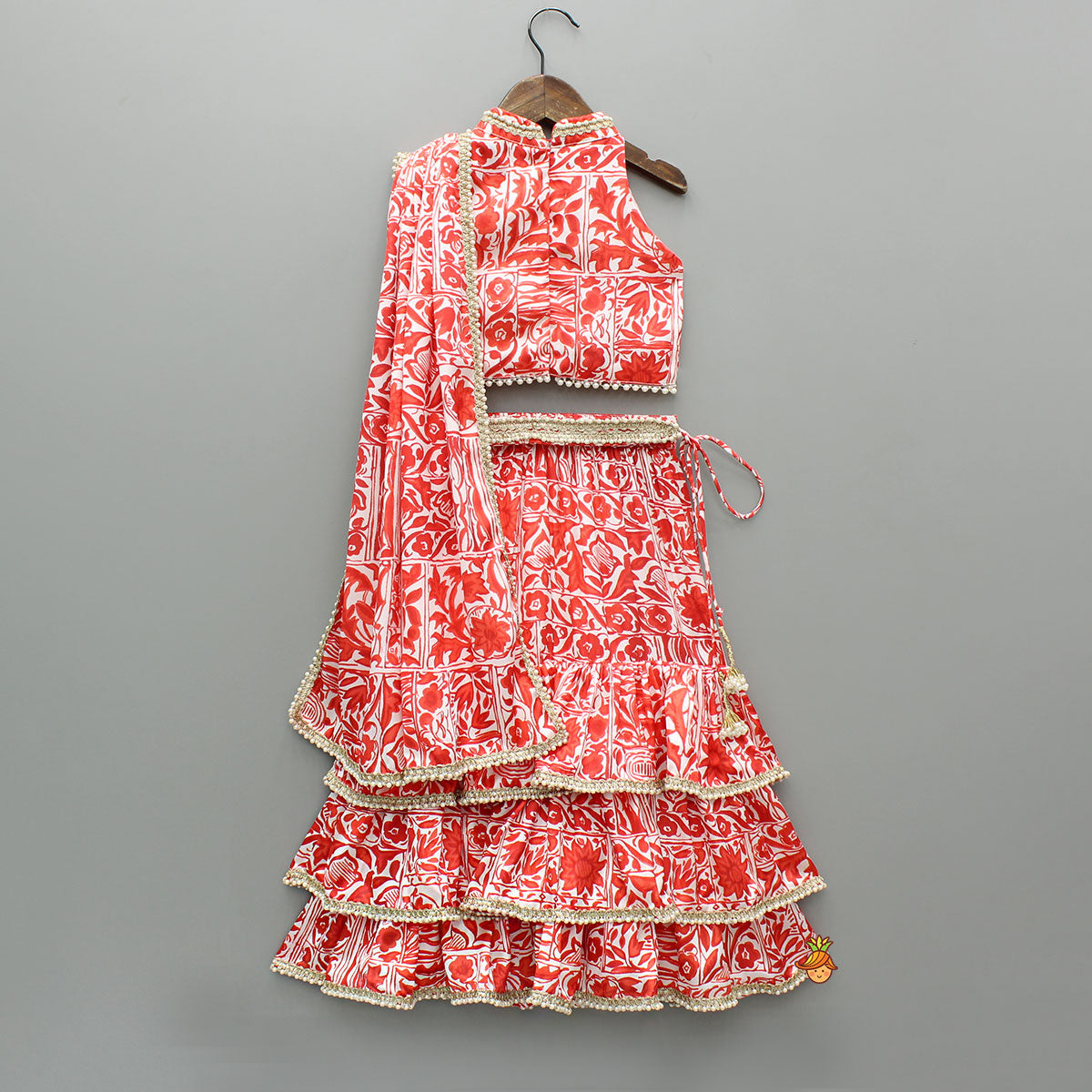 Pre Order: Red Printed Halter Neck Embellished Top And Layered Lehenga With Attached Draped Dupatta