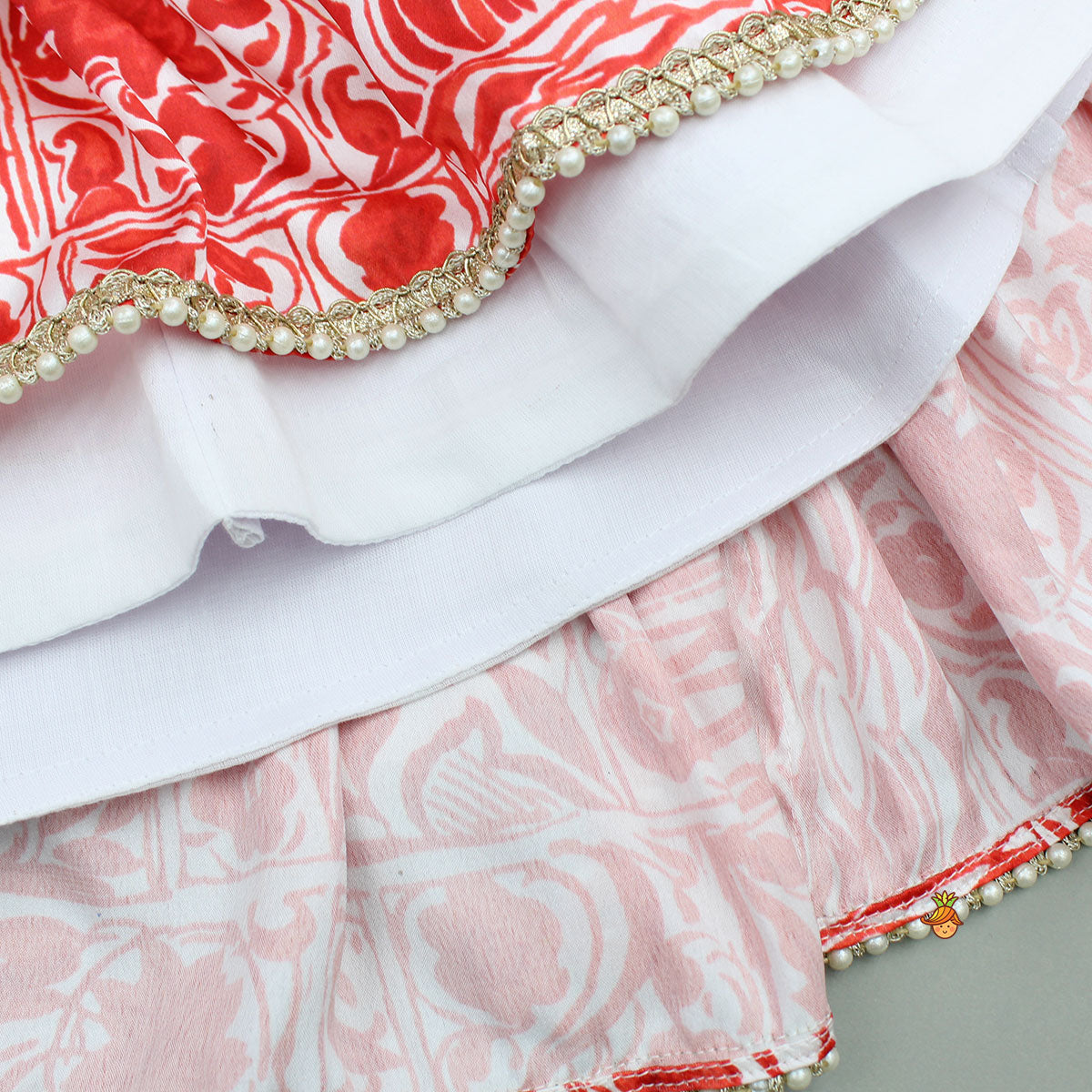 Pre Order: Red Printed Halter Neck Embellished Top And Layered Lehenga With Attached Draped Dupatta