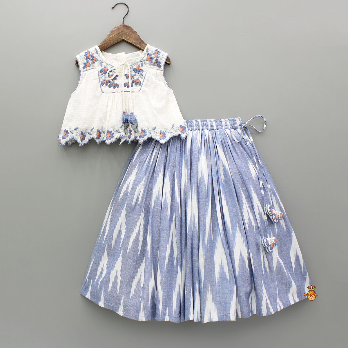 Pre Order: Cotton Top With Knot-Detailed Neckline And Ikat Printed Lehenga