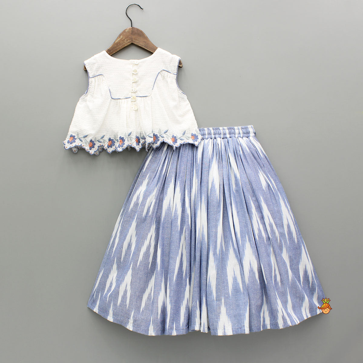 Pre Order: Cotton Top With Knot-Detailed Neckline And Ikat Printed Lehenga