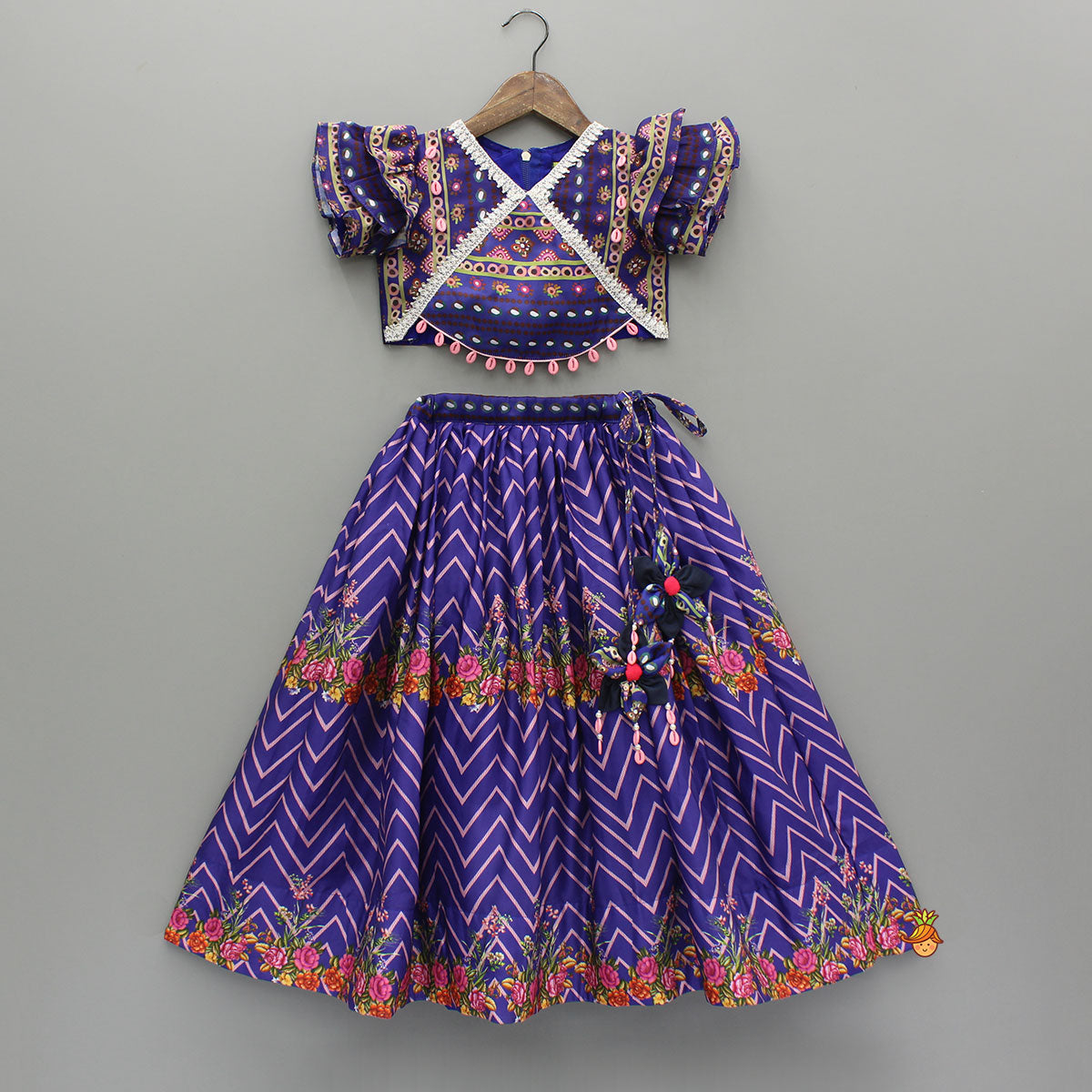 Pre Order: Layered Sleeves Blue Top And Fabric Flower Tassels Enhanced Lehenga With Purple Net Dupatta