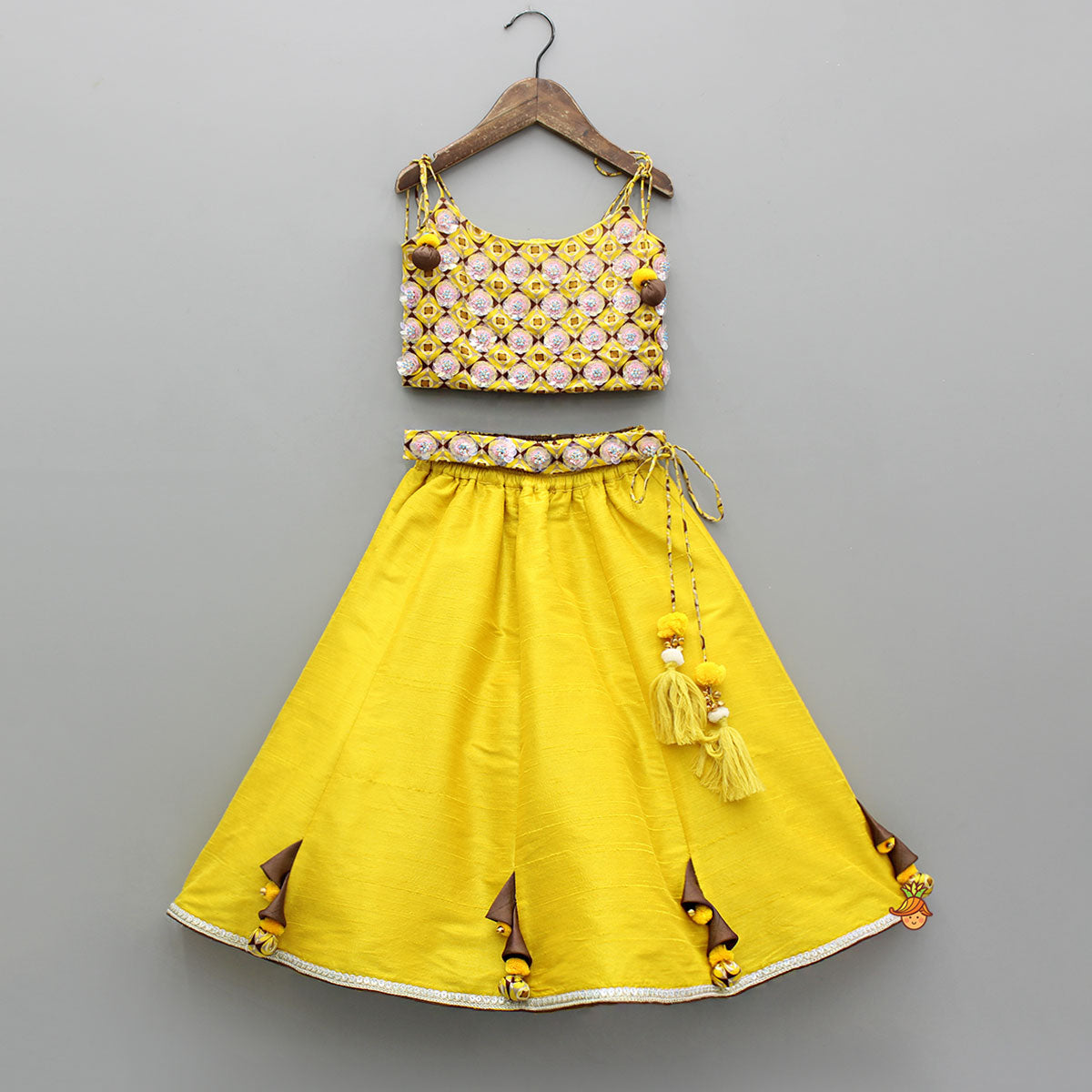 Pre Order: Flowers Adorned Smocked Tie Up Top With Lehenga And Waist Belt