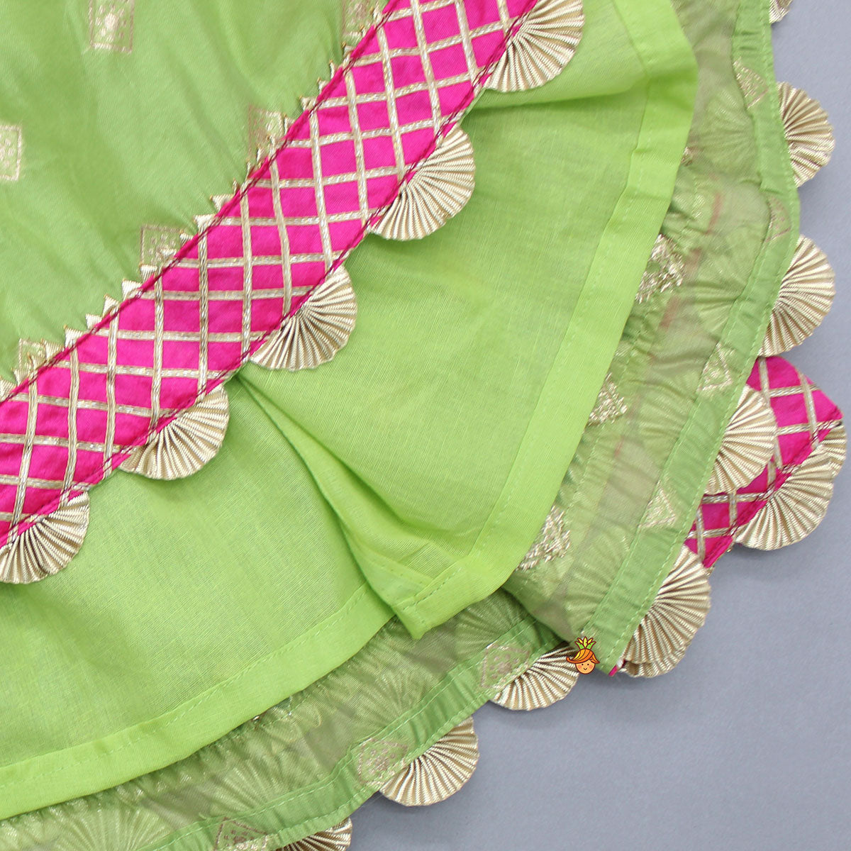 Pre Order: Contrasting Potli Buttons Detail Leaf Green Top And Gota Tassels Enhanced Lehenga