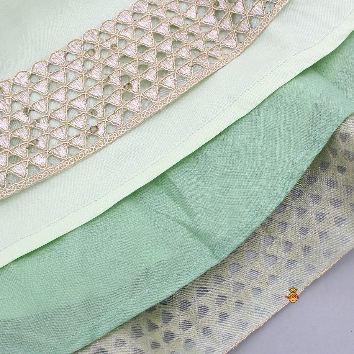 Pre Order: Floral Embroidered Green Sleeveless Top And Fabric Flower Tassels Adorned Lehenga With Ruffle Dupatta