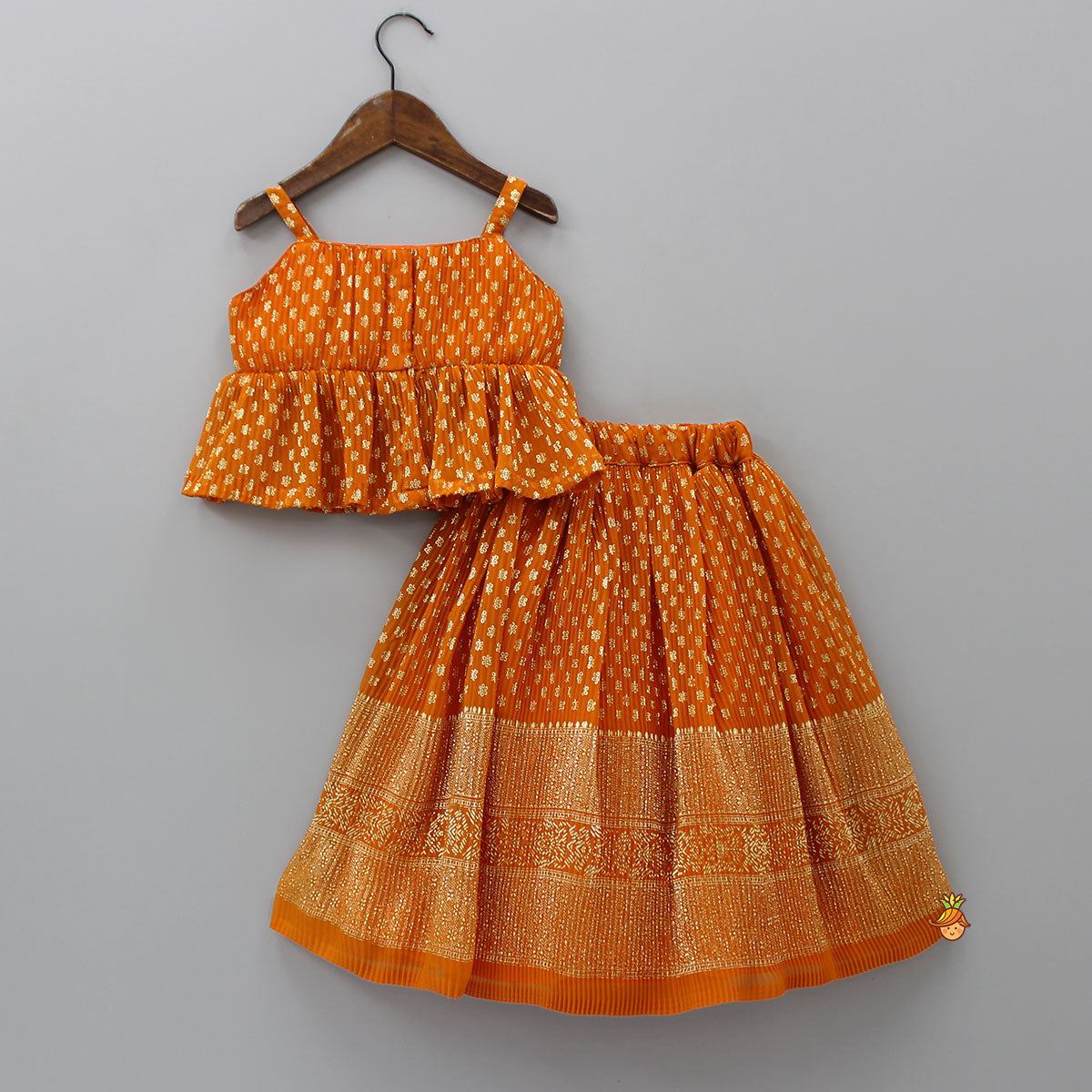 Pre Order: Rust Orange Pleated Georgette Top And Lehenga With Hair Clip