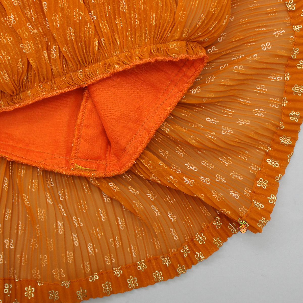 Pre Order: Rust Orange Pleated Georgette Top And Lehenga With Hair Clip