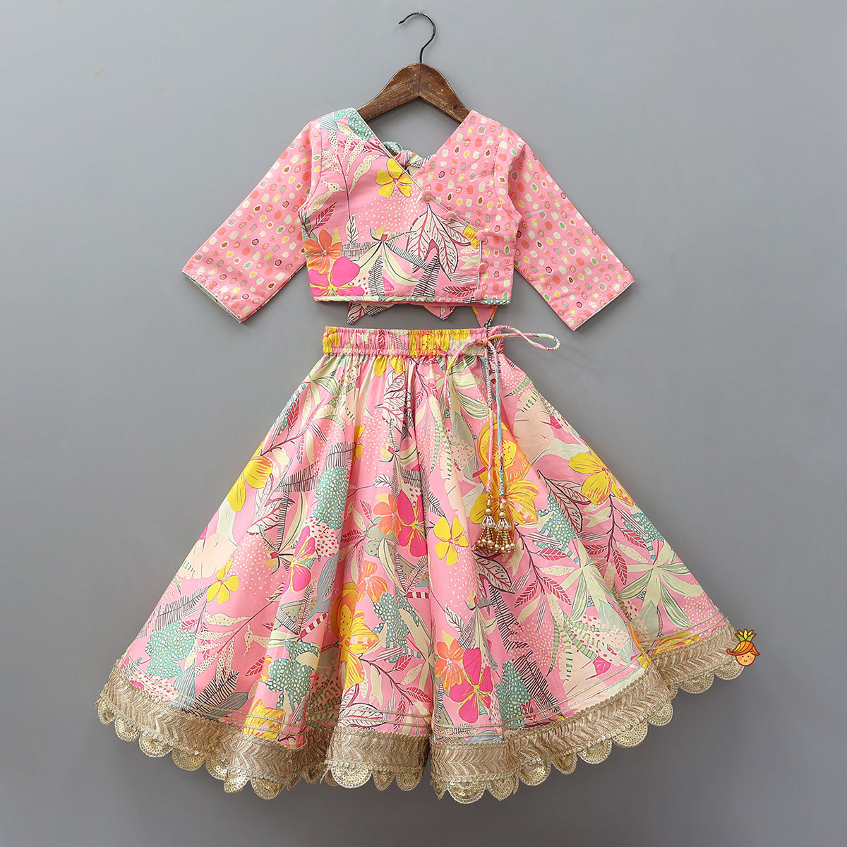 Pre Order: Buttons Adorned Pink Top And Scalloped Lace Work Floral Lehenga