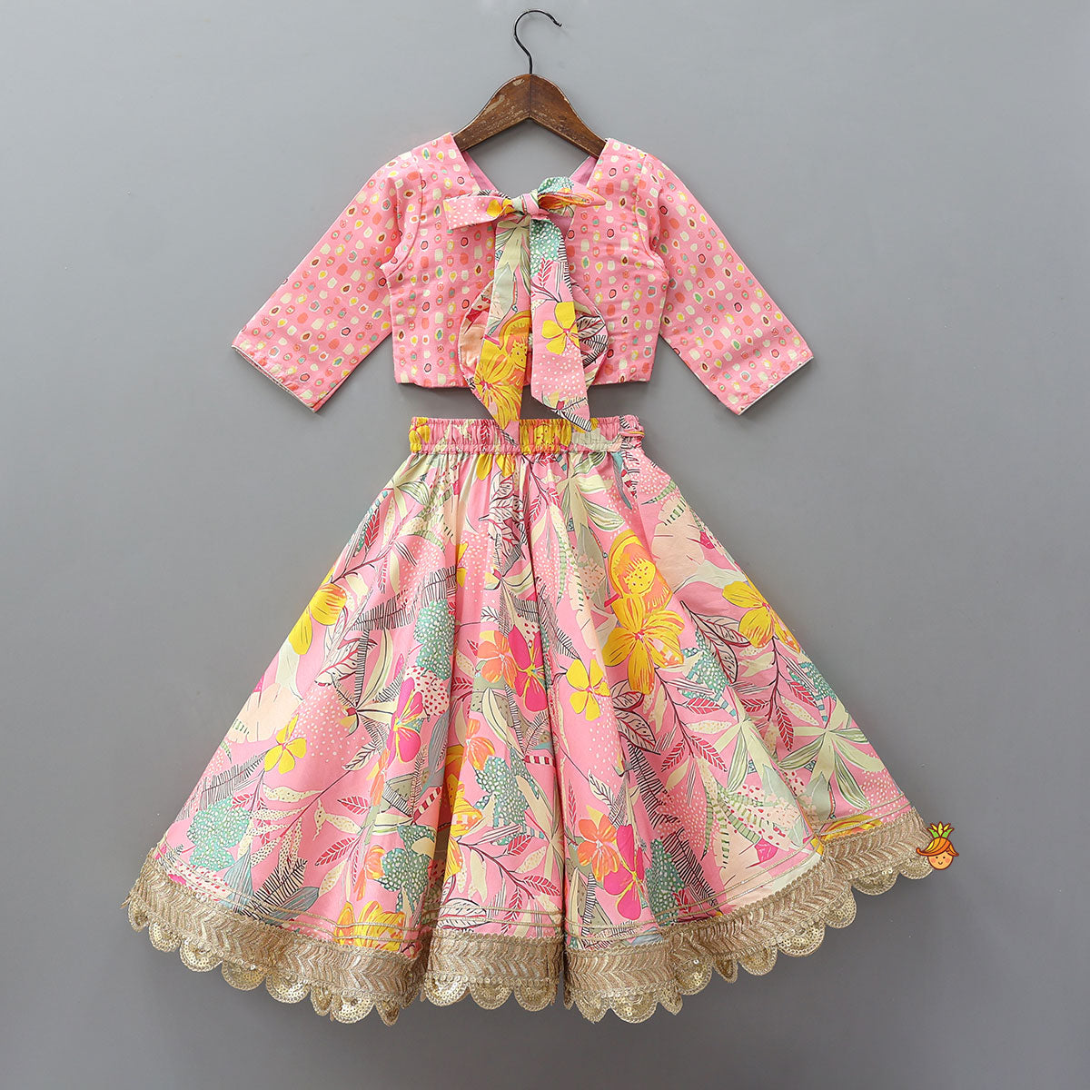 Pre Order: Buttons Adorned Pink Top And Scalloped Lace Work Floral Lehenga