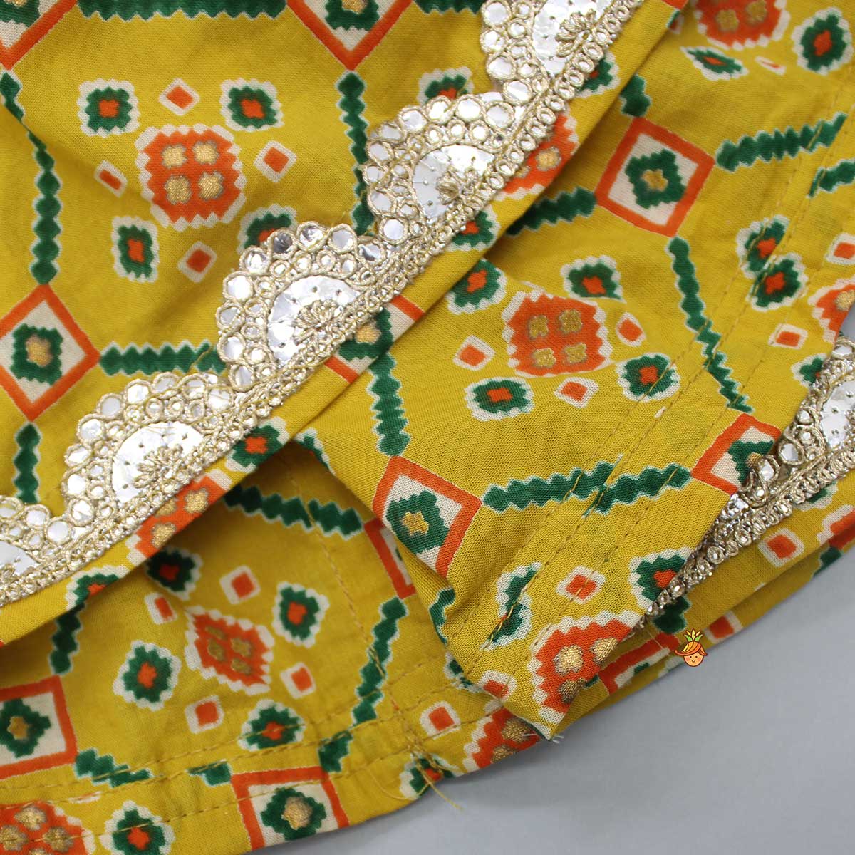 Pre Order: Fringes Tassels Enhanced Printed Mustard Top And Sharara With Net Green Dupatta