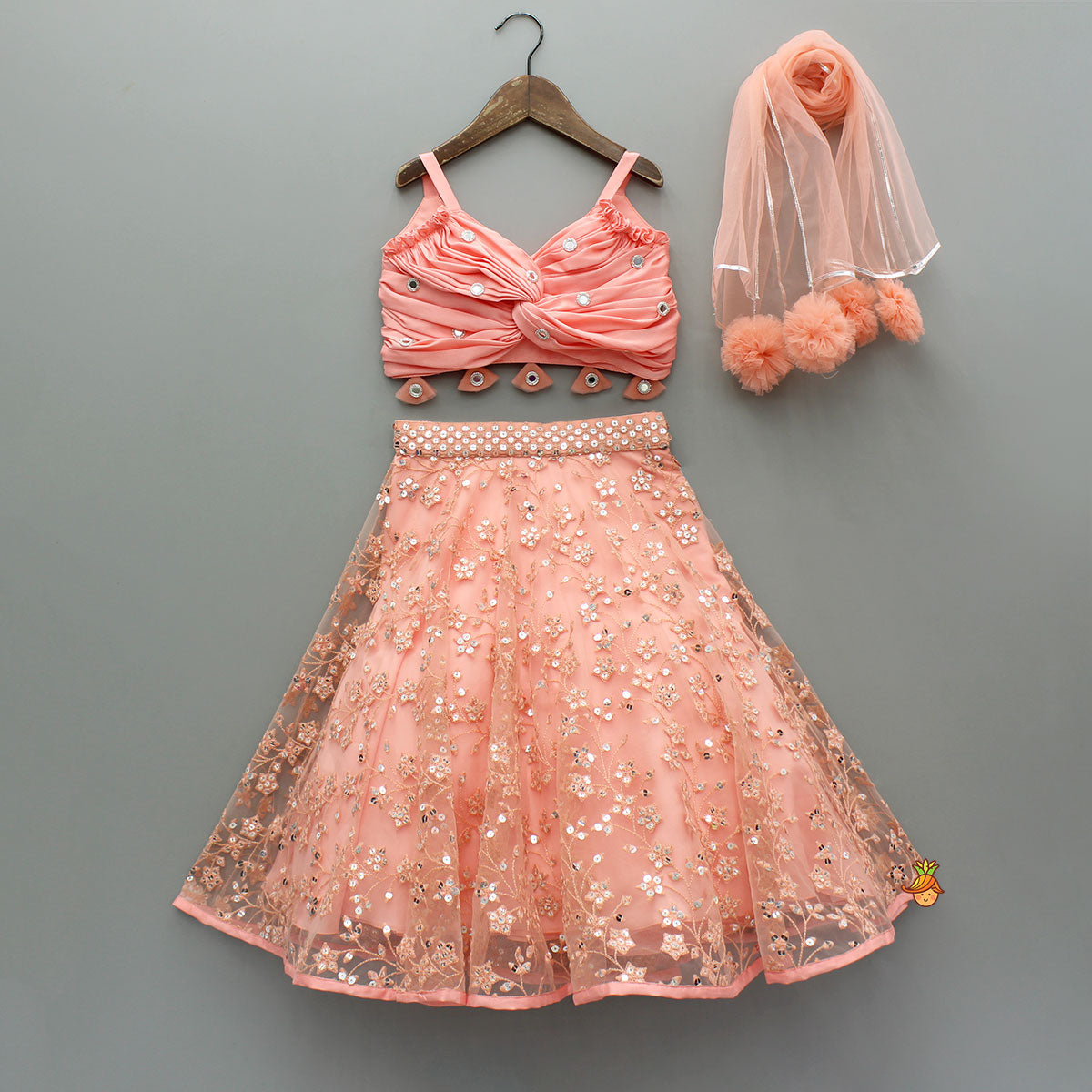 Pre Order: Peach Draped Knot Mirror Detailed Top With Embroidered Flared Lehenga And Dupatta