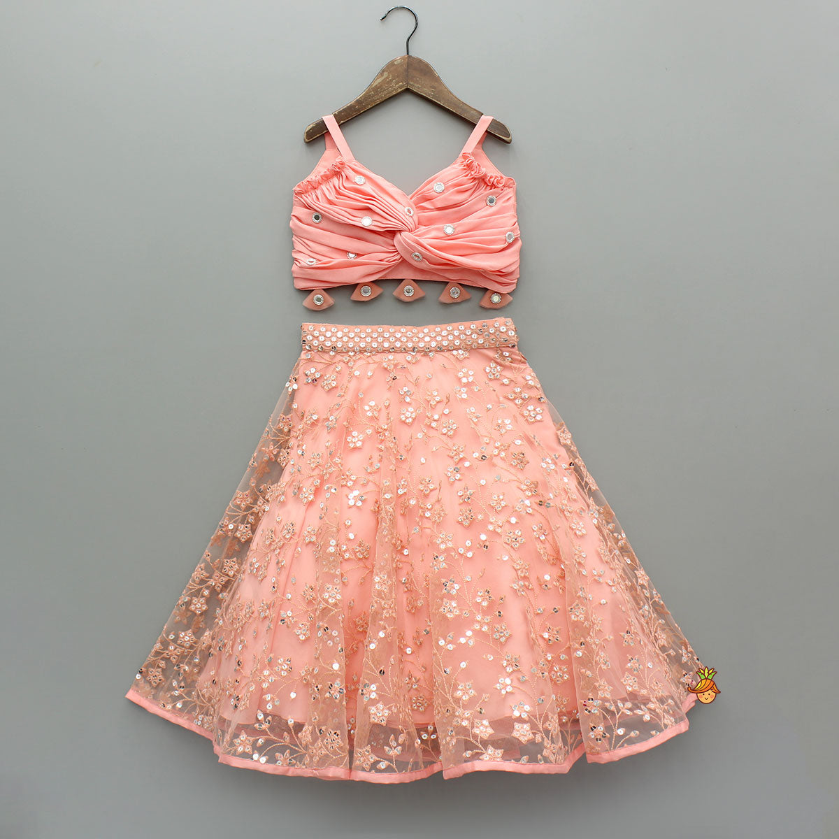Pre Order: Peach Draped Knot Mirror Detailed Top With Embroidered Flared Lehenga And Dupatta