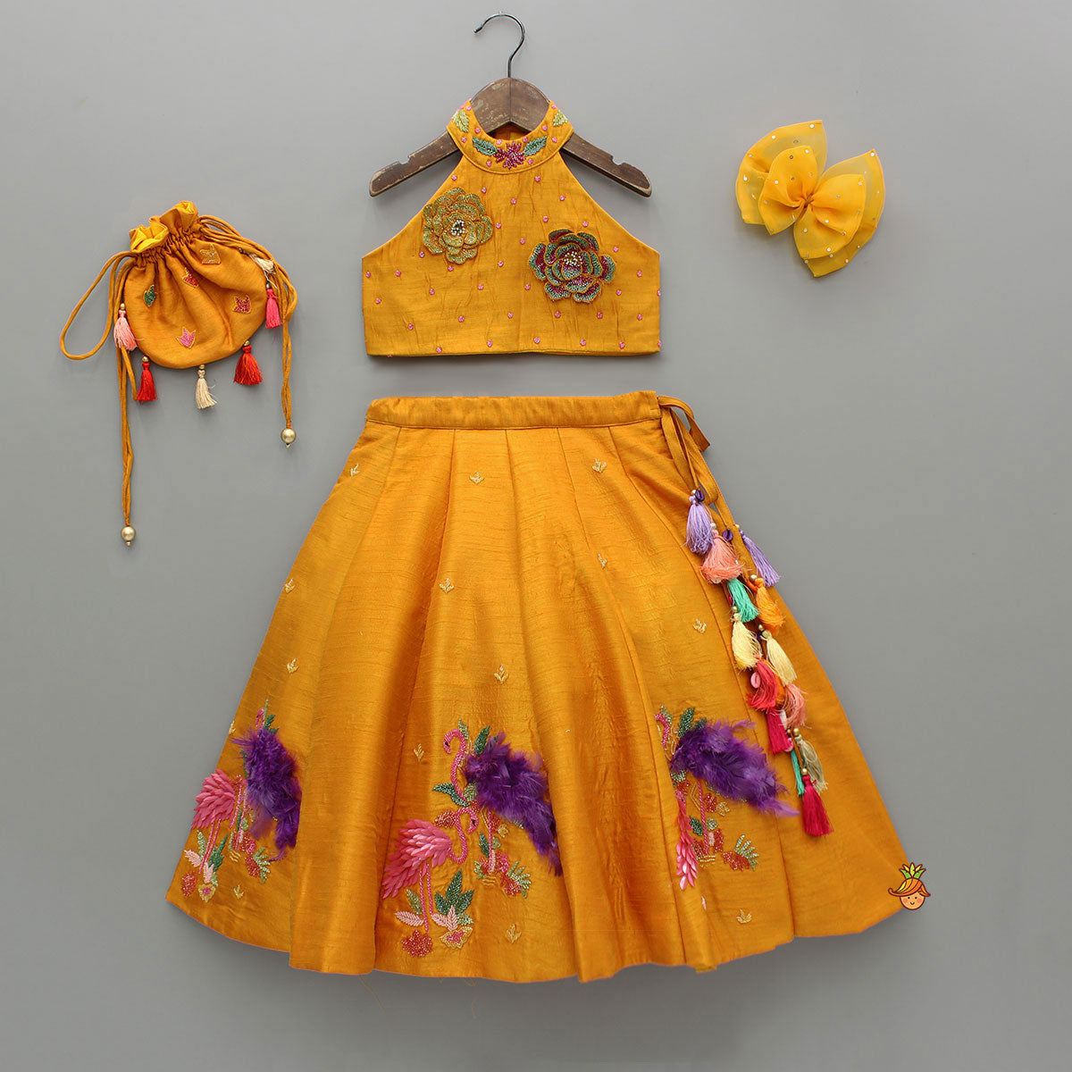 Pre Order: Floral Embroidered Halter Neck Top With Flared Lehenga And Bow Hair Clip With Potli Bag