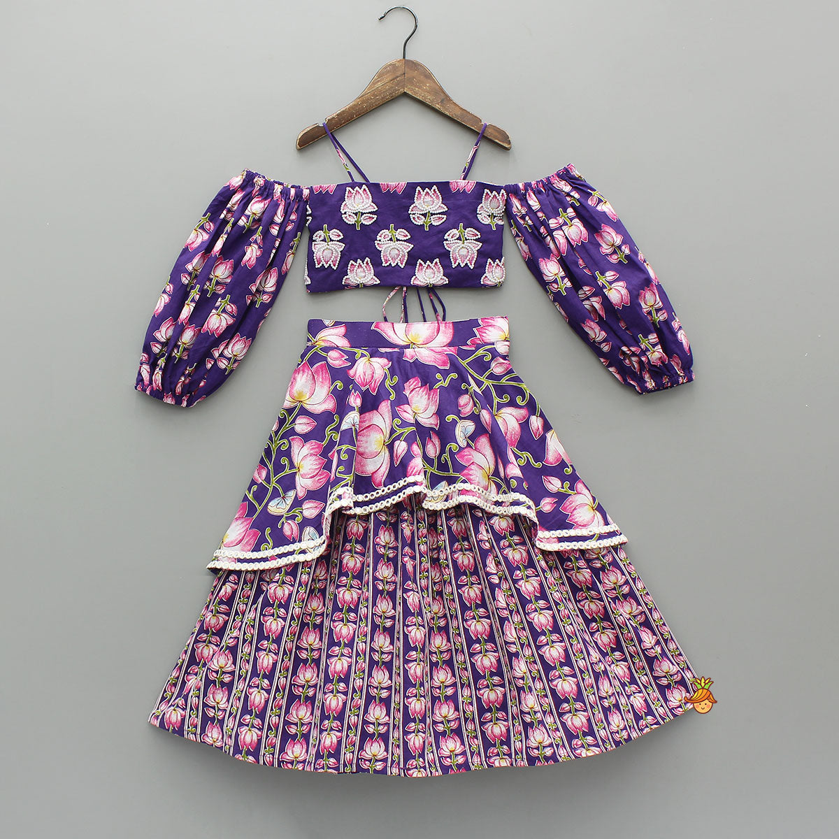 Pre Order: Lotus Embroidered Top And Layered Lehenga With Dupatta And Fringed Potli Bag